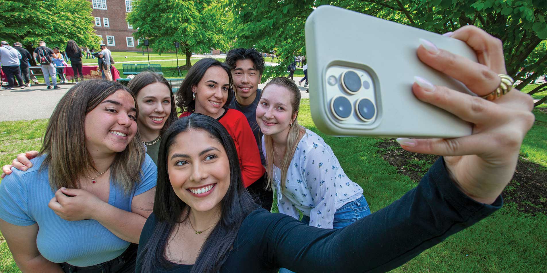students taking selfies outside